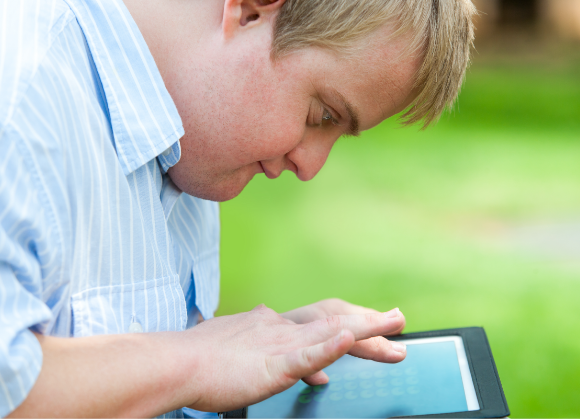 person with a visible disability using a tablet 
